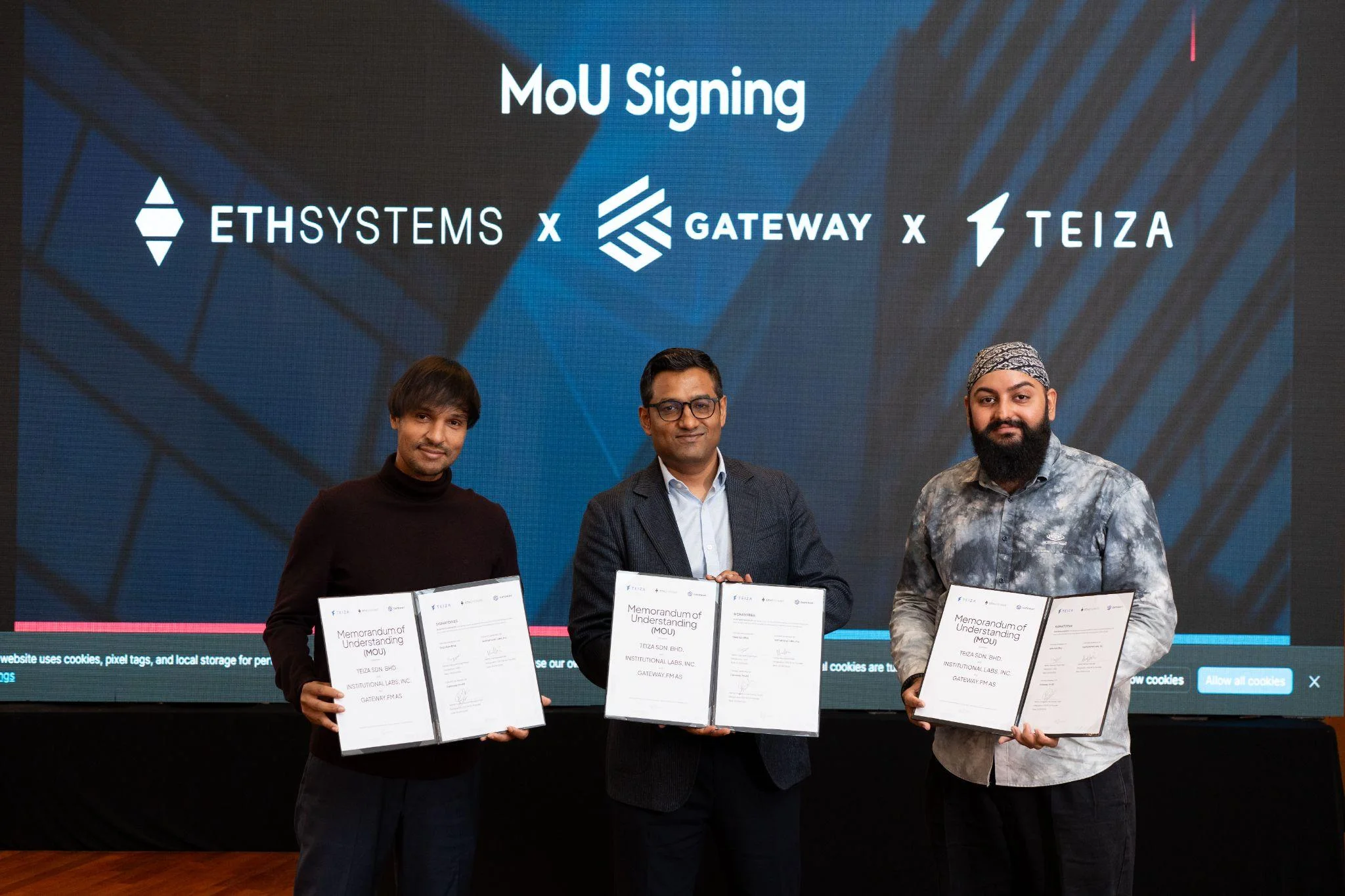 Representatives of EthSystems, Gateway and TEIZA holding the signed Memorandum of Understanding.